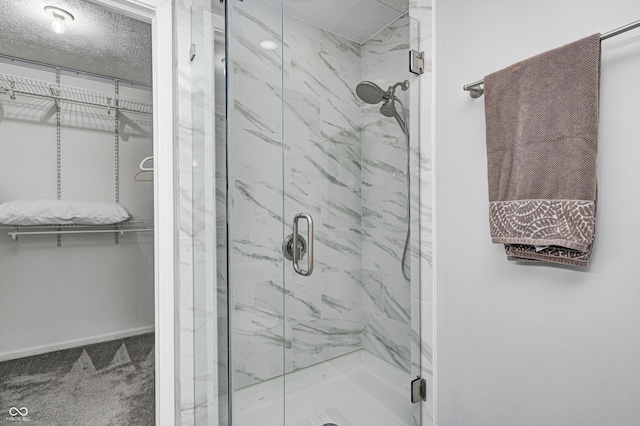 5909 Buttonwood Dr, Noblesville, IN 46062 - bathroom featuring a marble finish shower, a spacious closet, and baseboards