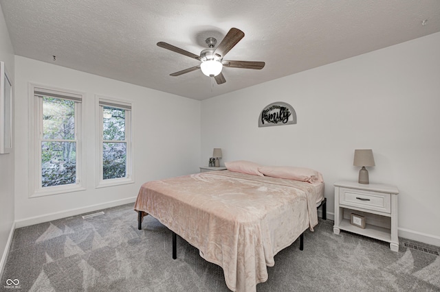 5909 Buttonwood Dr, Noblesville, IN 46062 - carpeted bedroom featuring baseboards, a textured ceiling, and a ceiling fan