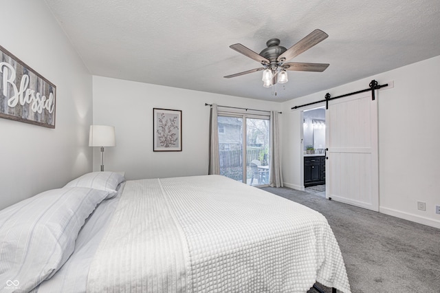 5909 Buttonwood Dr, Noblesville, IN 46062 - carpeted bedroom with a barn door, baseboards, a ceiling fan, and ensuite bath