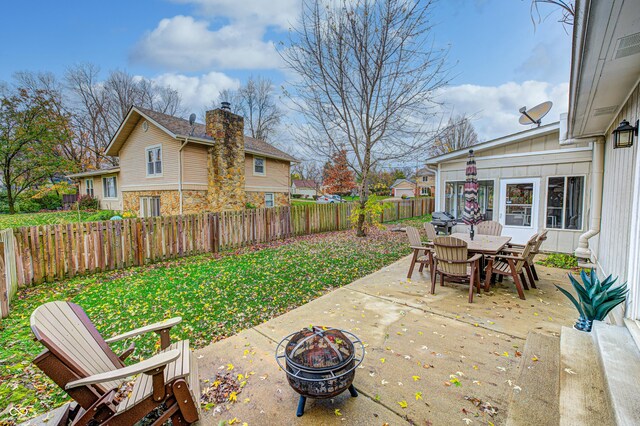 5909 Buttonwood Dr, Noblesville, IN 46062 - fenced backyard featuring a fire pit, a patio area, and outdoor dining space