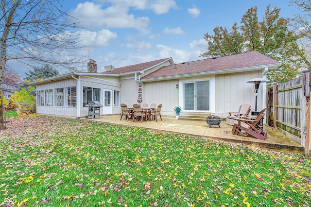 5909 Buttonwood Dr, Noblesville, IN 46062 - rear view of house with an outdoor fire pit, a chimney, a sunroom, and a patio area