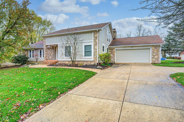5909 Buttonwood Dr, Noblesville, IN 46062 - traditional home with stone siding, concrete driveway, a front lawn, a chimney, and an attached garage