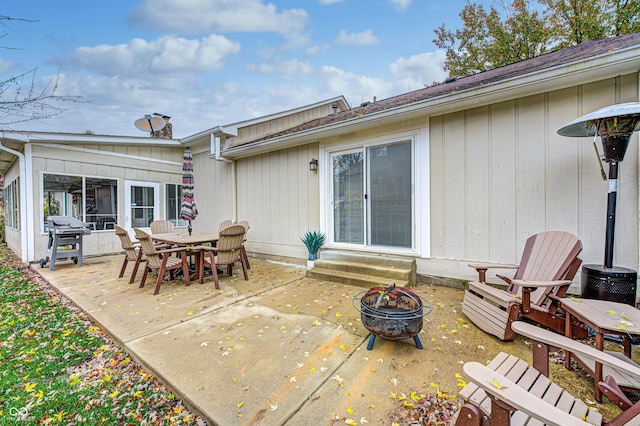 5909 Buttonwood Dr, Noblesville, IN 46062 - rear view of house with a patio area, entry steps, an outdoor fire pit, and board and batten siding