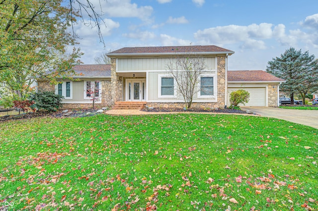 5909 Buttonwood Dr, Noblesville, IN 46062 - view of front facade featuring a garage, stone siding, a front yard, and concrete driveway