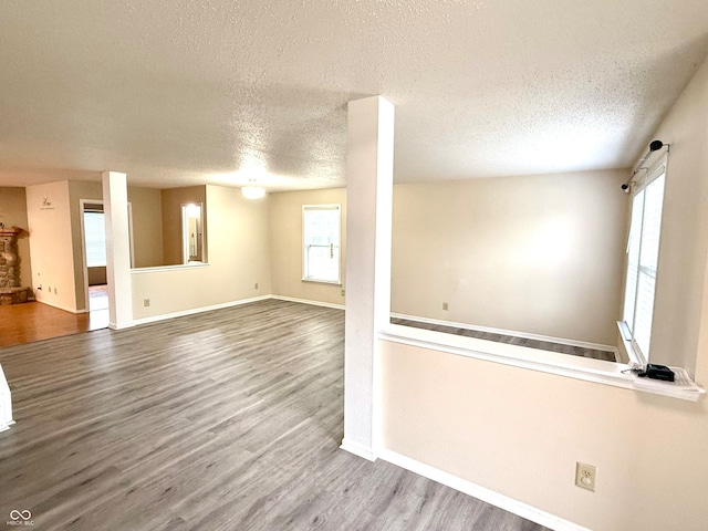 interior space with wood-type flooring and a textured ceiling