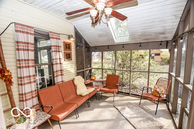 sunroom / solarium with ceiling fan, lofted ceiling with skylight, and wood ceiling