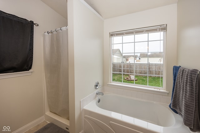 bathroom with separate shower and tub and plenty of natural light