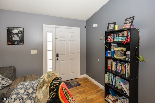 foyer featuring hardwood / wood-style flooring and lofted ceiling