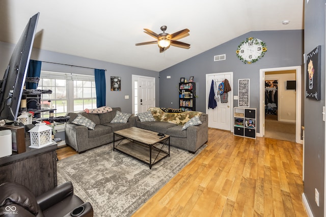 living room with ceiling fan, wood-type flooring, and lofted ceiling