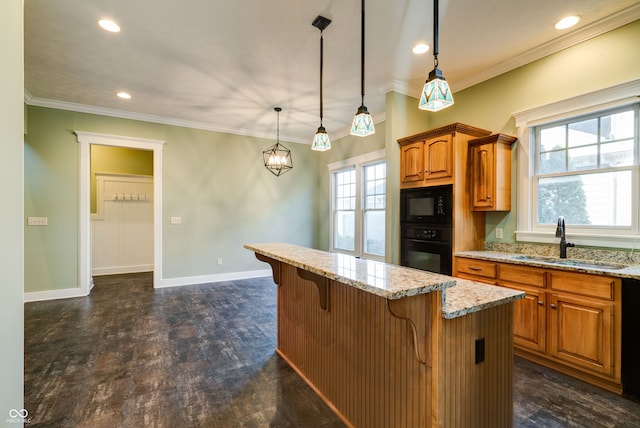 kitchen featuring hanging light fixtures, a wealth of natural light, black appliances, and sink