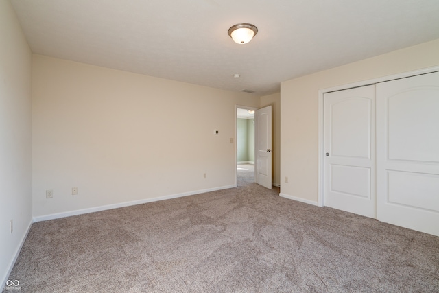 unfurnished bedroom with carpet and a closet