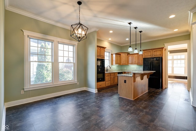 7290 Lockford Walk N, Avon, IN 46123 - kitchen with black appliances, a kitchen bar, baseboards, a kitchen island, and a chandelier