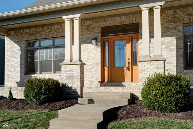 view of exterior entry featuring a porch