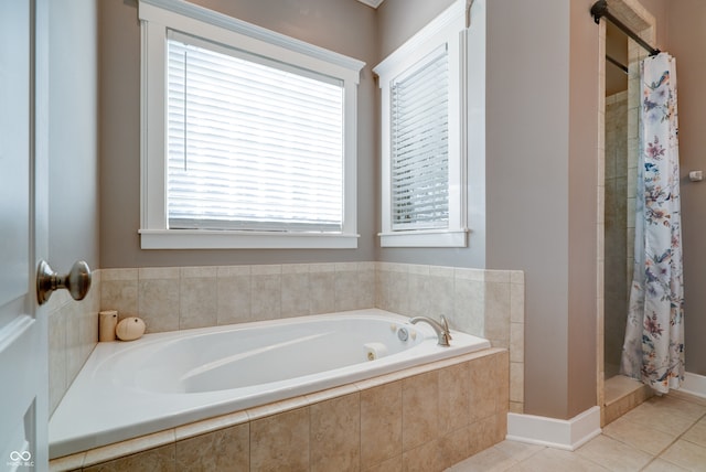 bathroom with tile patterned floors and shower with separate bathtub