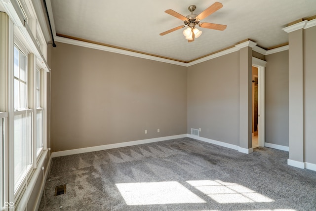 spare room featuring ceiling fan, a healthy amount of sunlight, carpet flooring, and ornamental molding