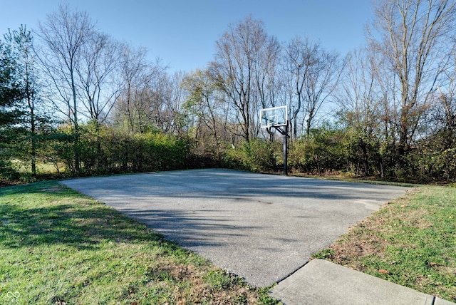 view of sport court with a lawn