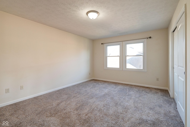 7290 Lockford Walk N, Avon, IN 46123 - unfurnished bedroom featuring carpet flooring, a closet, baseboards, and a textured ceiling