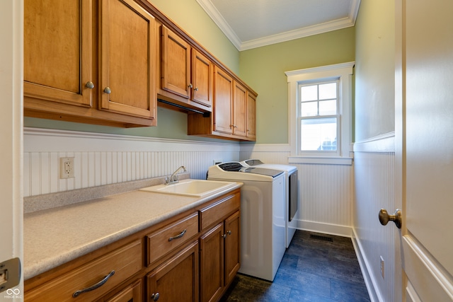 washroom featuring cabinets, ornamental molding, sink, and independent washer and dryer