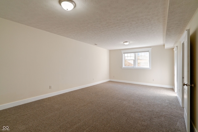 carpeted empty room with a textured ceiling