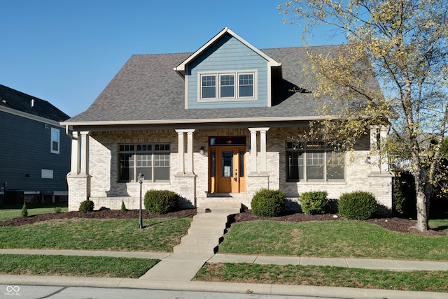 view of front facade featuring central air condition unit, a porch, and a front yard