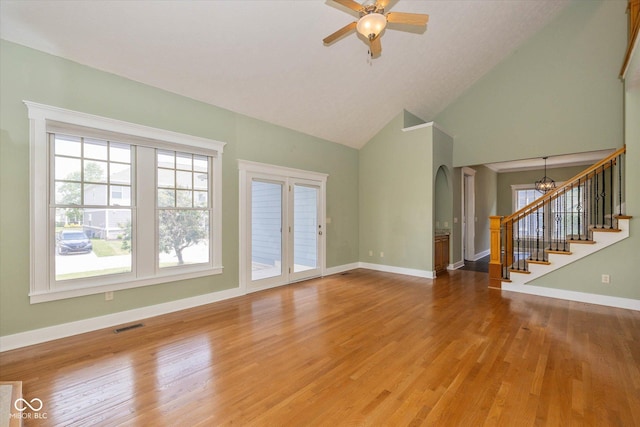 7290 Lockford Walk N, Avon, IN 46123 - unfurnished living room with stairway, a ceiling fan, high vaulted ceiling, light wood finished floors, and arched walkways