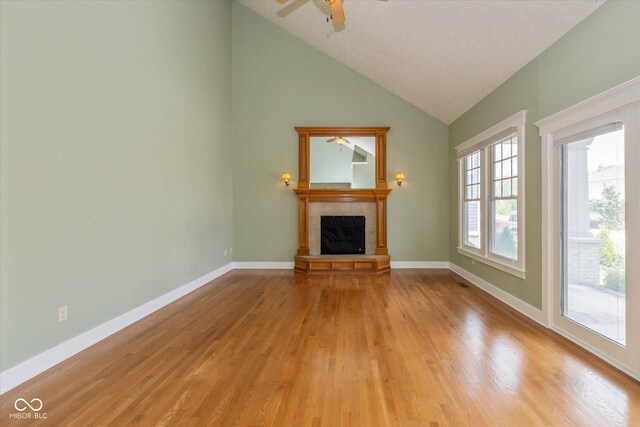 7290 Lockford Walk N, Avon, IN 46123 - unfurnished living room with a fireplace, light wood finished floors, high vaulted ceiling, and a ceiling fan