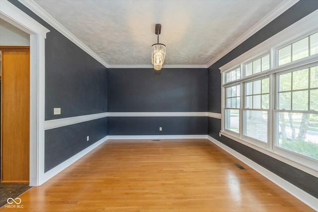 7290 Lockford Walk N, Avon, IN 46123 - unfurnished room with light wood-style floors, a chandelier, and ornamental molding