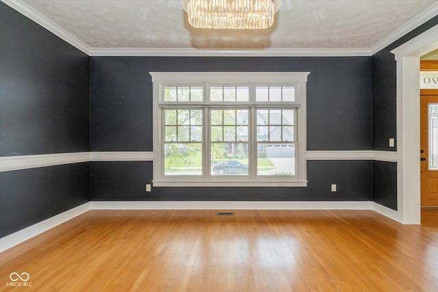 7290 Lockford Walk N, Avon, IN 46123 - unfurnished room featuring wood finished floors, a chandelier, and crown molding