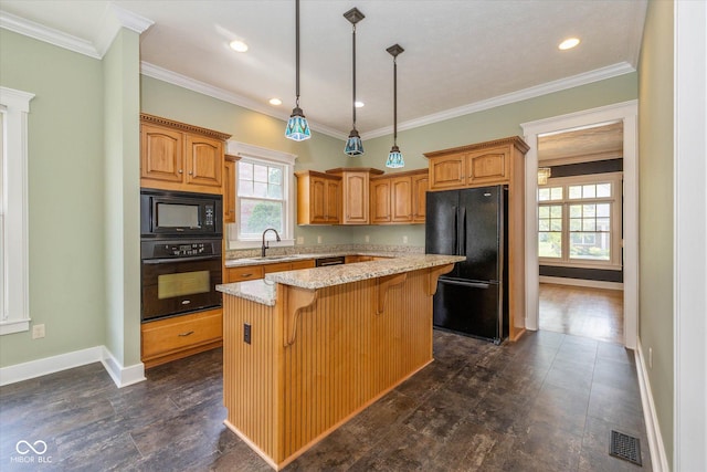7290 Lockford Walk N, Avon, IN 46123 - kitchen with black appliances, a kitchen island, light stone countertops, a breakfast bar area, and decorative light fixtures