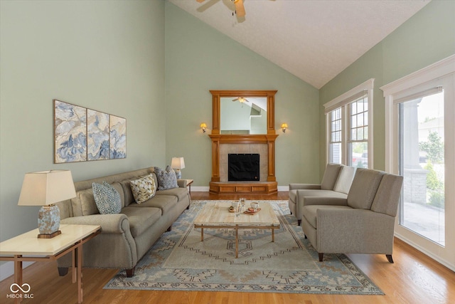 7290 Lockford Walk N, Avon, IN 46123 - living area featuring wood finished floors, high vaulted ceiling, a fireplace, and ceiling fan