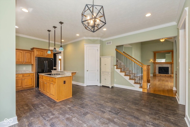 7290 Lockford Walk N, Avon, IN 46123 - kitchen with a center island, recessed lighting, dark wood-style flooring, light stone countertops, and decorative light fixtures