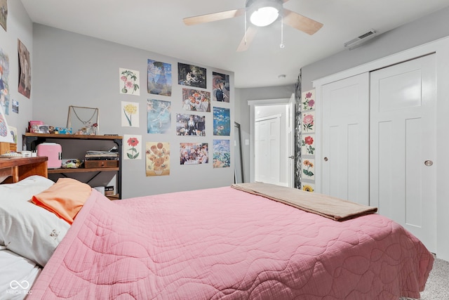 carpeted bedroom with a closet and ceiling fan