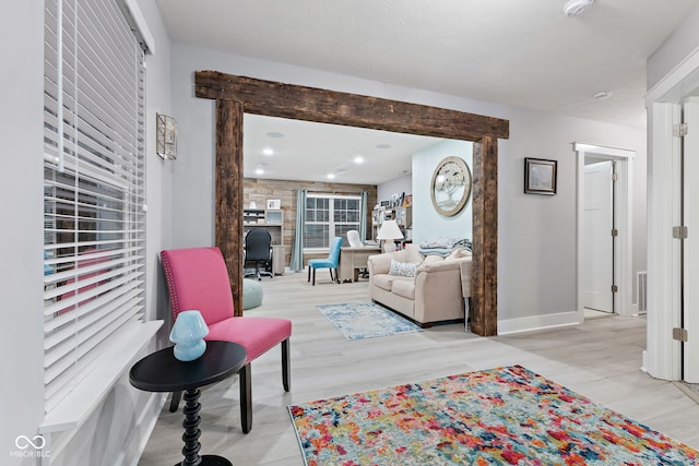 living room with light hardwood / wood-style floors and a textured ceiling