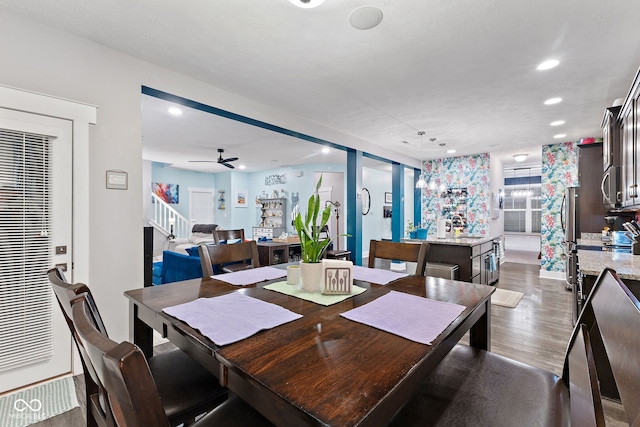 dining space with dark hardwood / wood-style floors and ceiling fan