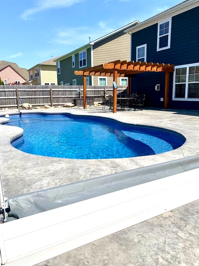 view of swimming pool featuring a patio area and a pergola