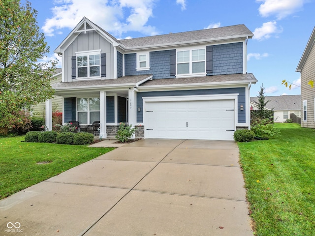 craftsman-style house featuring covered porch, a front yard, and a garage