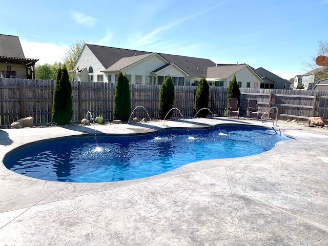 view of swimming pool featuring pool water feature and a patio