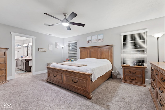 carpeted bedroom featuring connected bathroom and ceiling fan