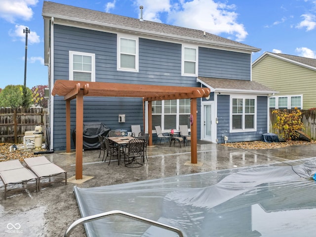 rear view of house featuring a pergola and a patio area