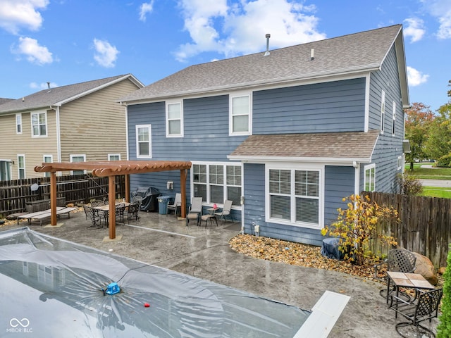 rear view of property with a pergola and a patio area