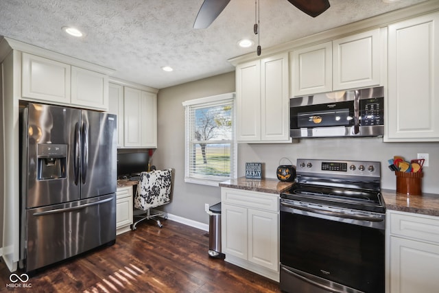 kitchen featuring dark hardwood / wood-style flooring, appliances with stainless steel finishes, dark stone countertops, and a textured ceiling