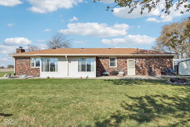 rear view of house featuring a patio and a lawn