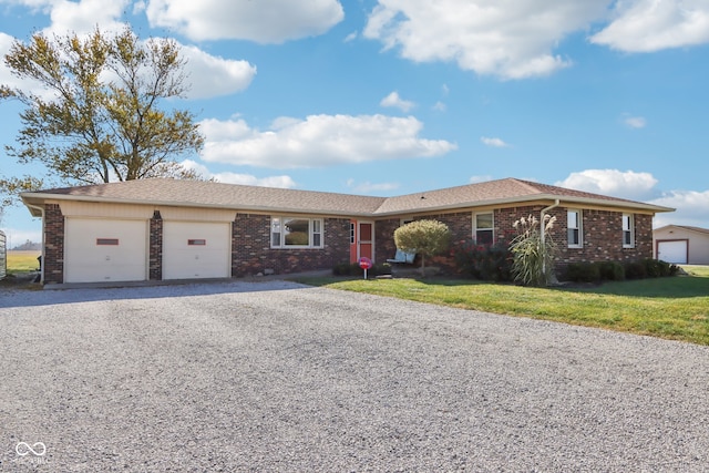 ranch-style home with a garage and a front yard