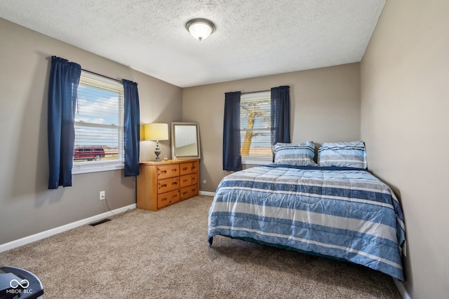 carpeted bedroom with a textured ceiling