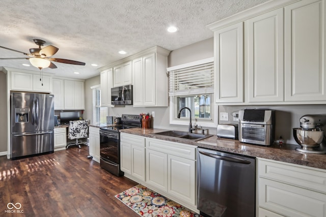 kitchen with white cabinetry, appliances with stainless steel finishes, a textured ceiling, dark hardwood / wood-style floors, and sink