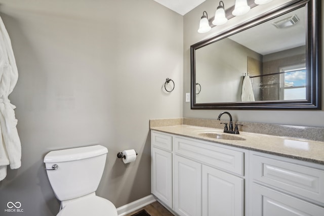 bathroom with vanity and toilet