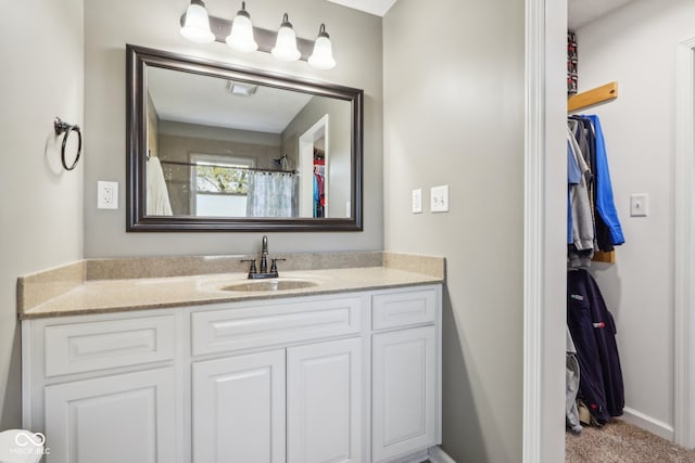 bathroom featuring a shower with curtain and vanity