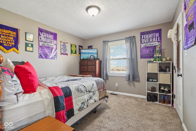 bedroom with carpet and a textured ceiling