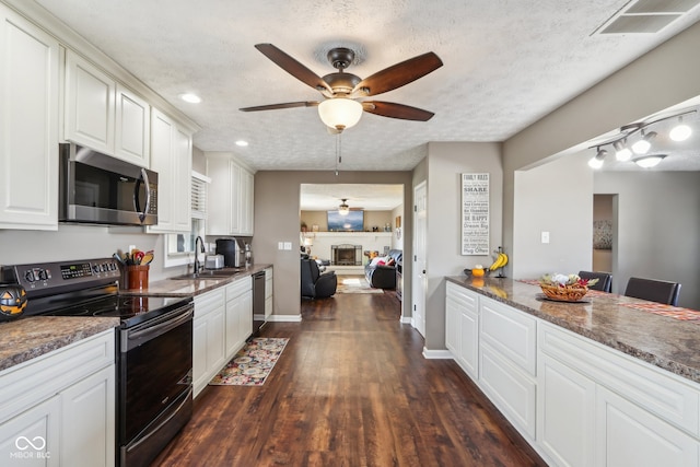 kitchen featuring stainless steel appliances, a textured ceiling, sink, and dark hardwood / wood-style flooring