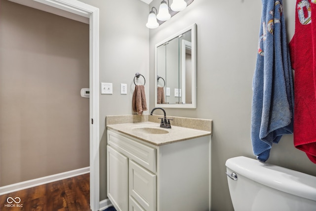 bathroom featuring hardwood / wood-style floors, vanity, and toilet